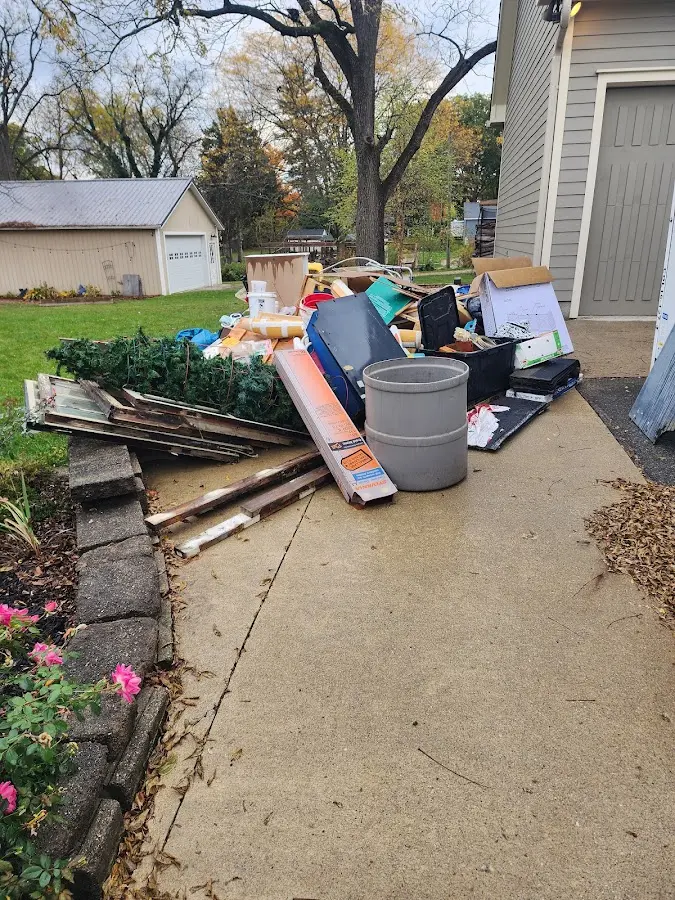 Dumpster being loaded with debris for Roofing Dumpster Rental in Iona